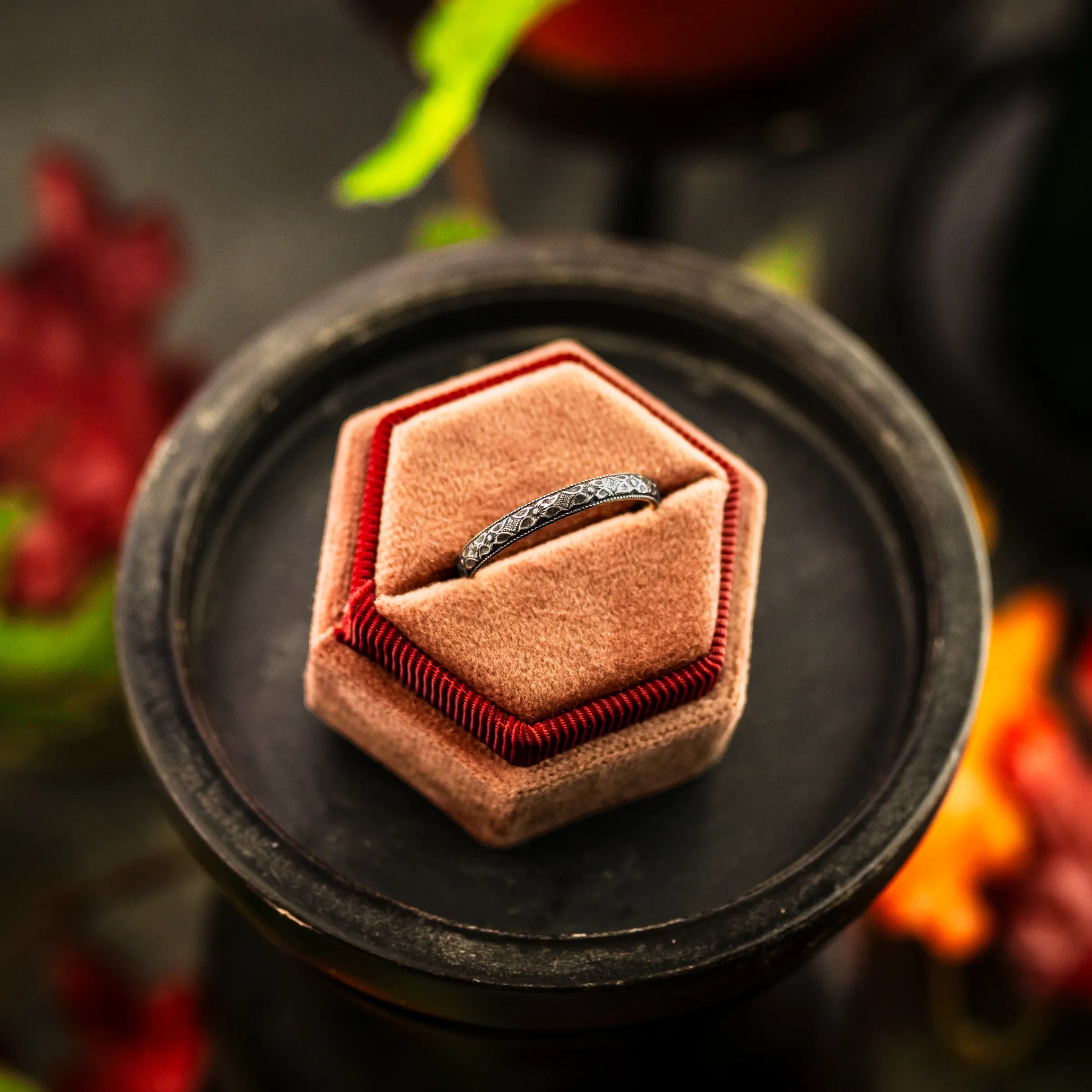 A dainty,floral engagement ring in a hexagon ring box. the ring is made from sterling silver