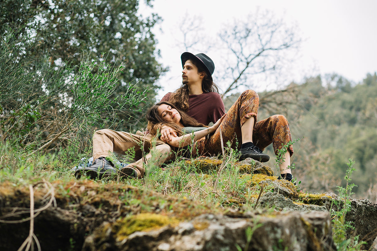 Young couple laying together, relaxed in the grassy forest