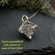 Photo of the textured backside of these thistle necklaces. This photo shows that you can personalize this necklace with engraving.
