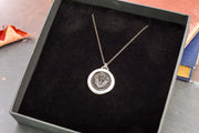 Round thistle necklace in a gift box.