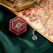 Stylized photo of the trinity knot necklace and matching ring