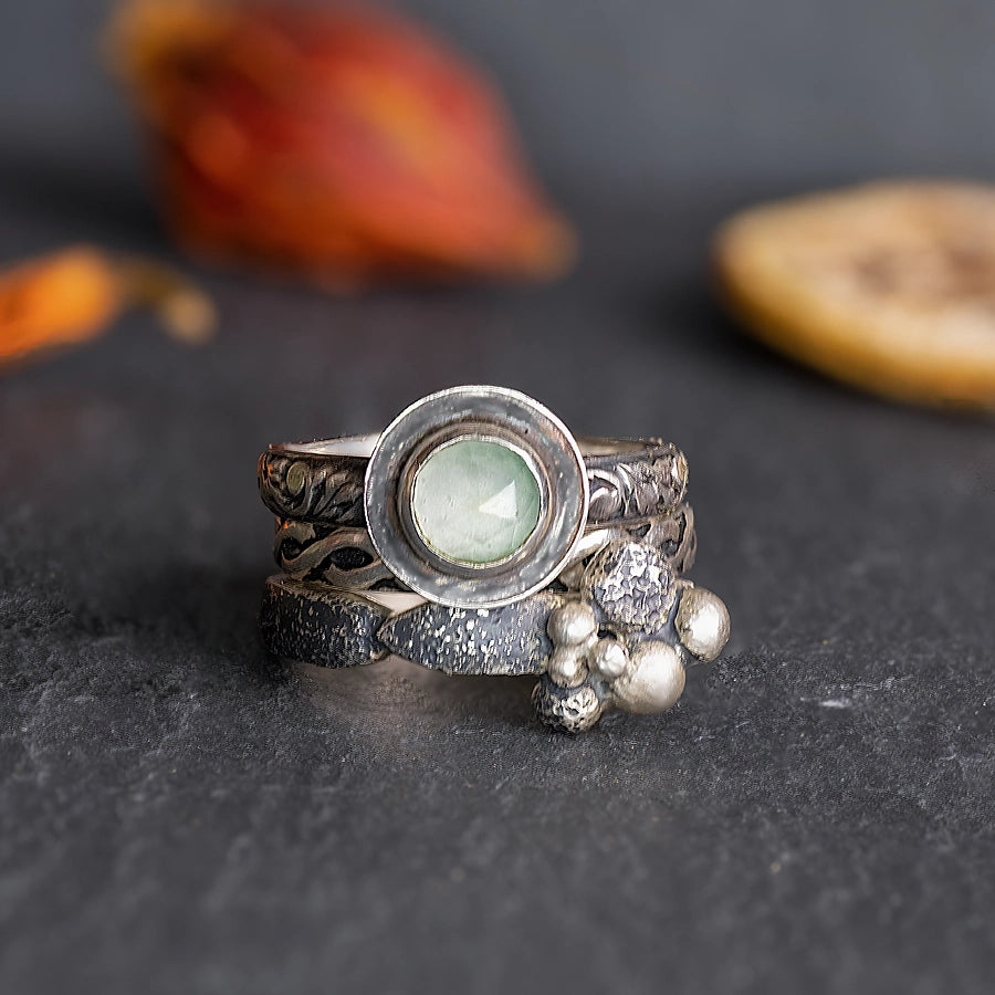 Unique set of handcrafted silver stacking rings featuring light green stone
