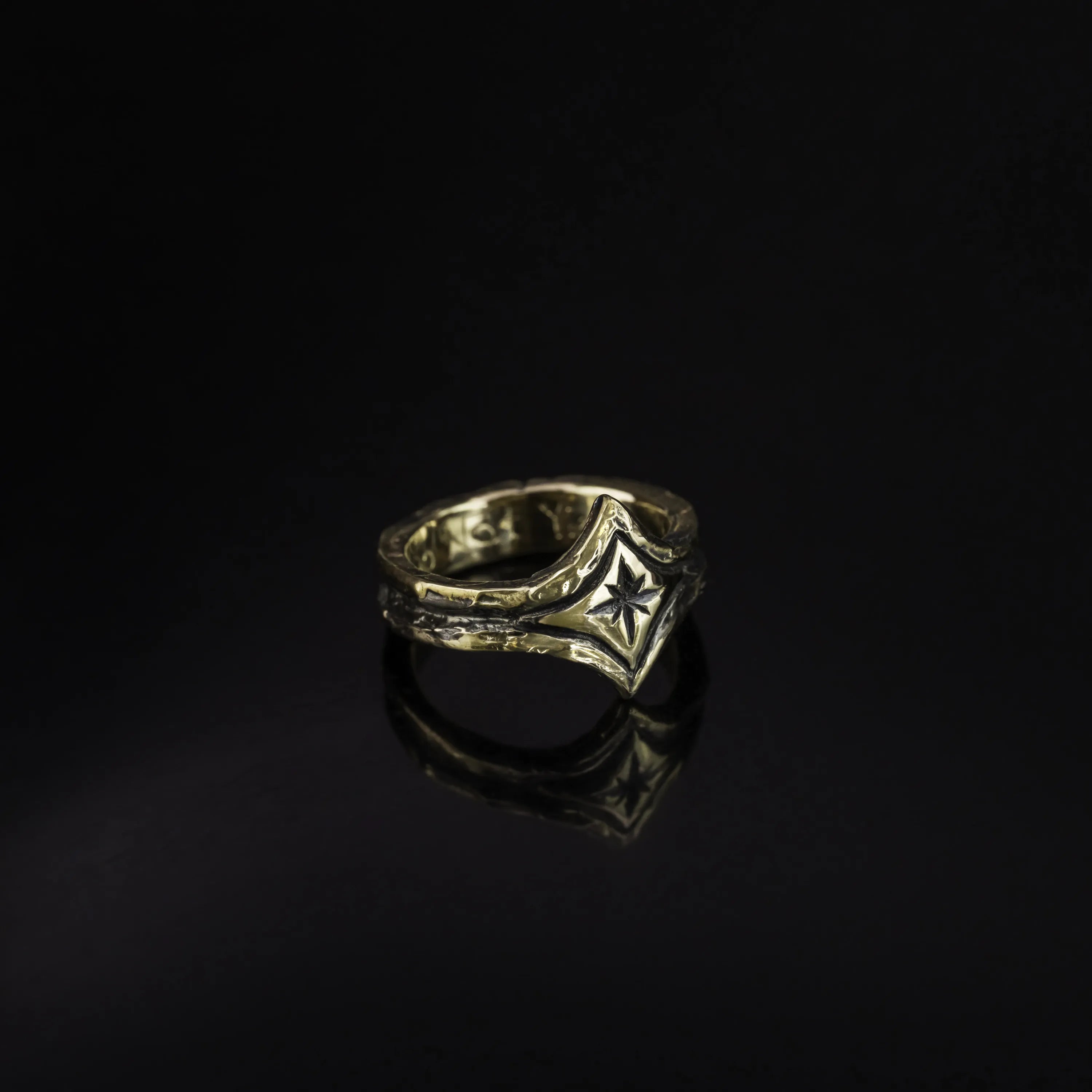 10K yellow Gold ring with a focal center star on a black background