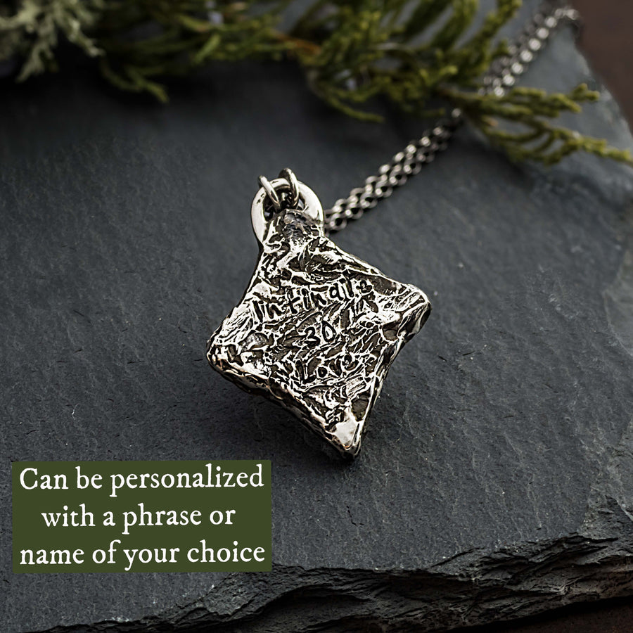 Photo of the textured backside of these thistle necklaces. This photo shows that you can personalize this necklace with engraving.