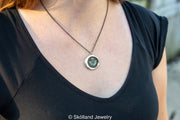 Scottish thistle wax seal necklace being worn on a dual cable chain