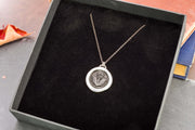 Round thistle necklace in a gift box. 